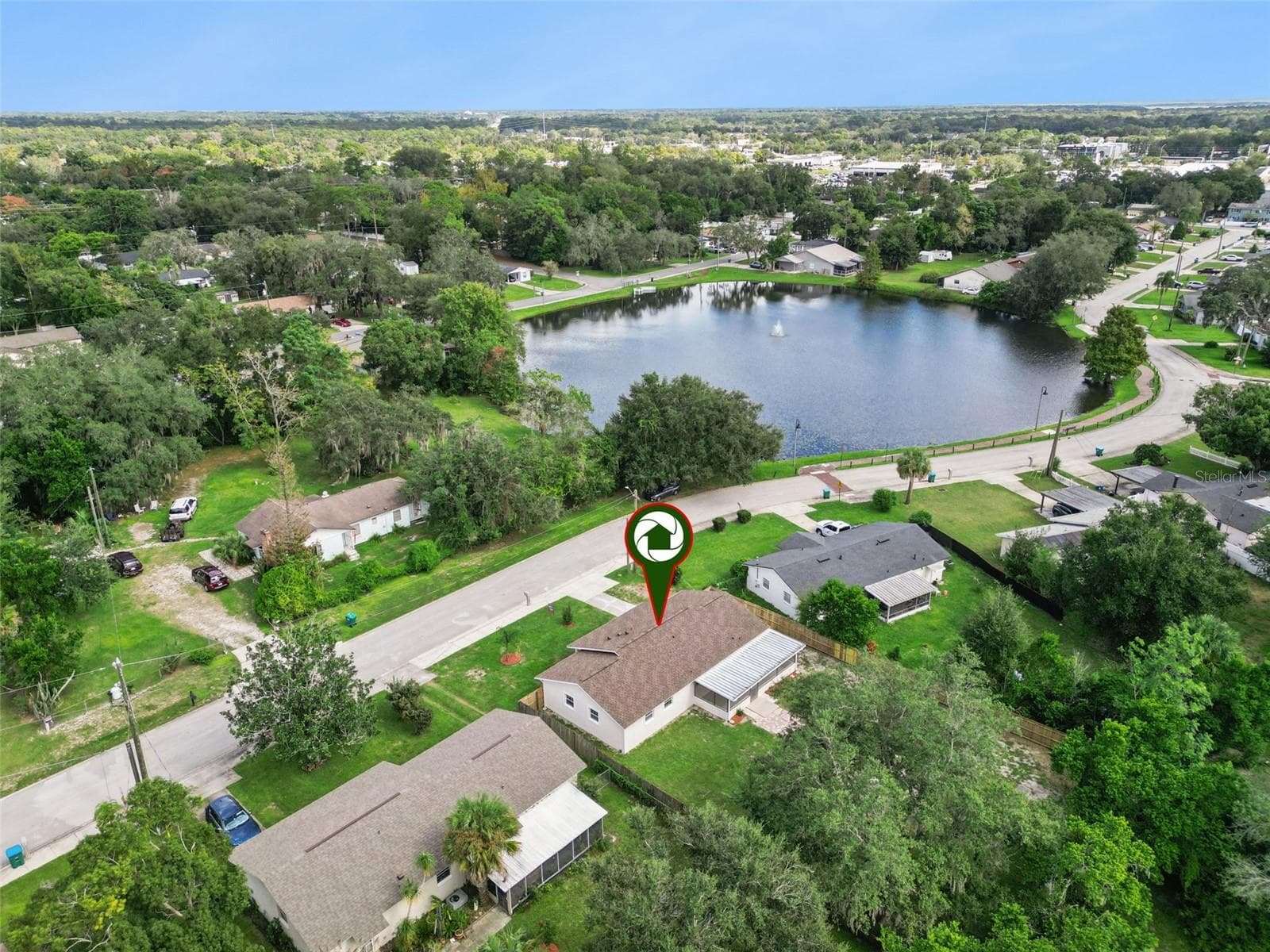 Aerial Lake Proximity Pin: Drone photo showcasing the property location pin relative to the nearby neighborhood lake and surrounding street layout - 720 GEORGIA AVE, LONGWOOD