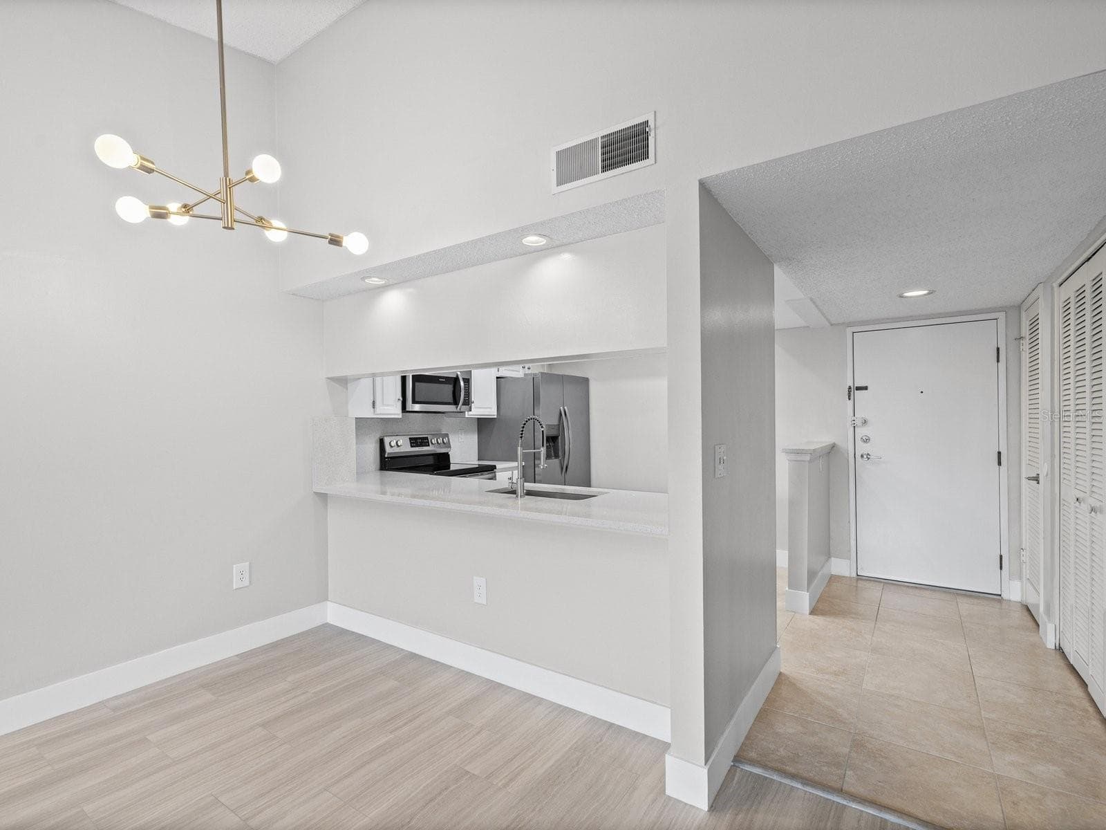 Vault ceiling and new modern light fixture in dining room - 2593 COUNTRYSIDE BLVD #7304, CLEARWATER