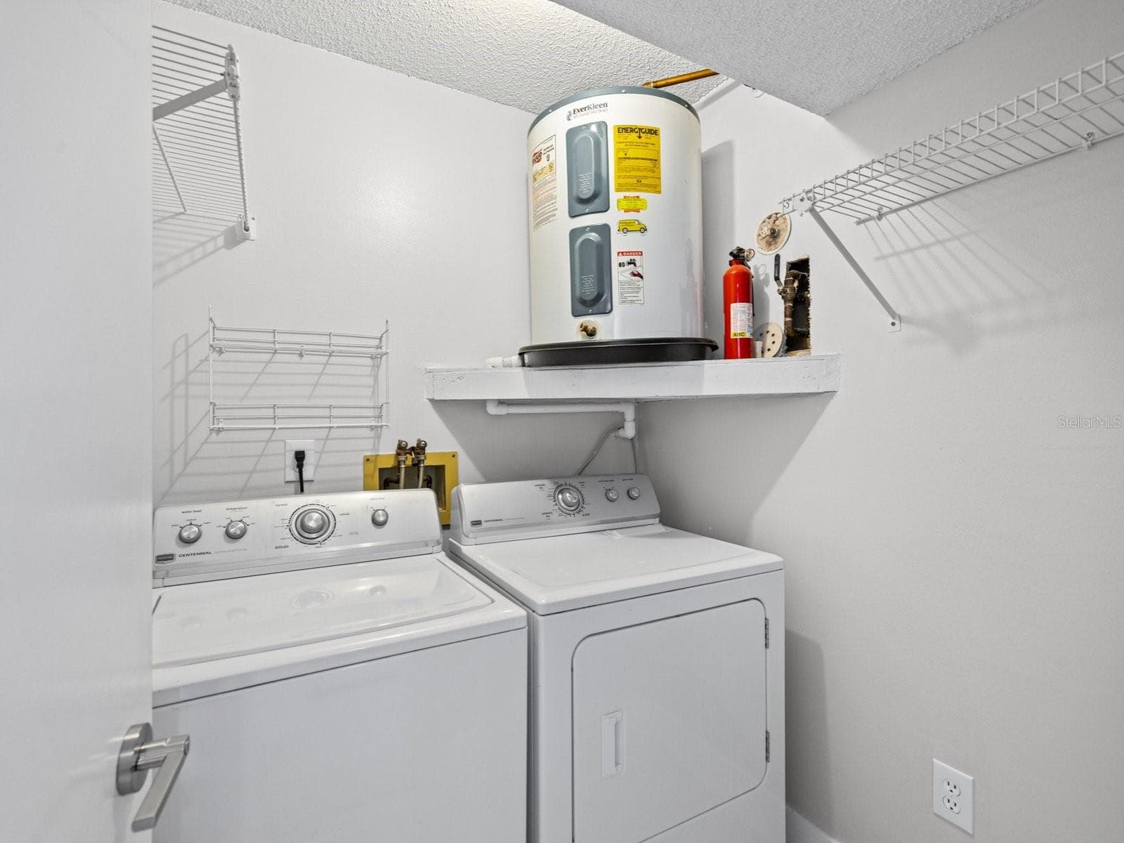 Laundry room off hallway by 2nd bedroom - 2593 COUNTRYSIDE BLVD #7304, CLEARWATER
