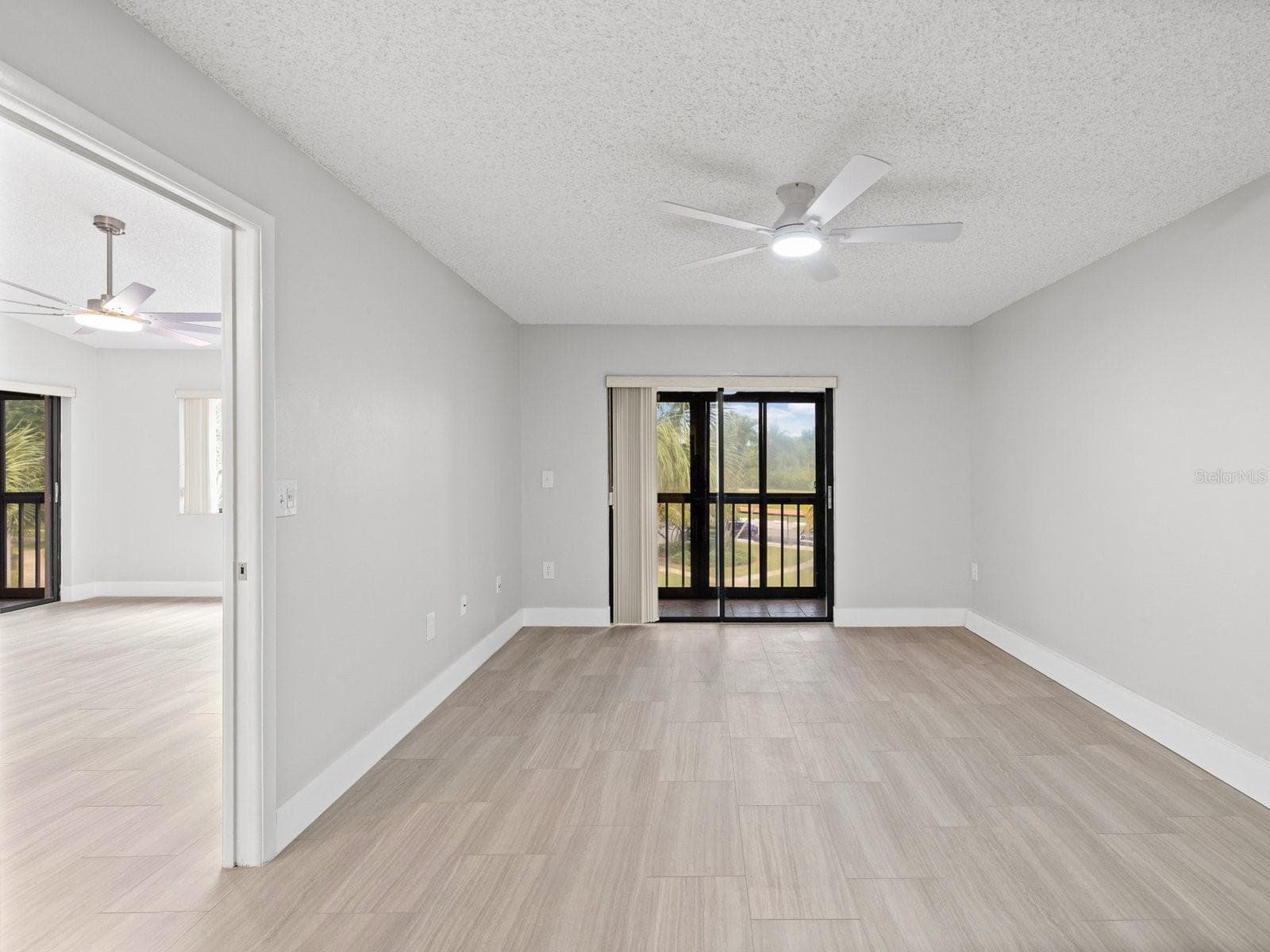Primary bedroom is split plan on opposite side from guest room with pocket door and private patio - 2593 COUNTRYSIDE BLVD #7304, CLEARWATER