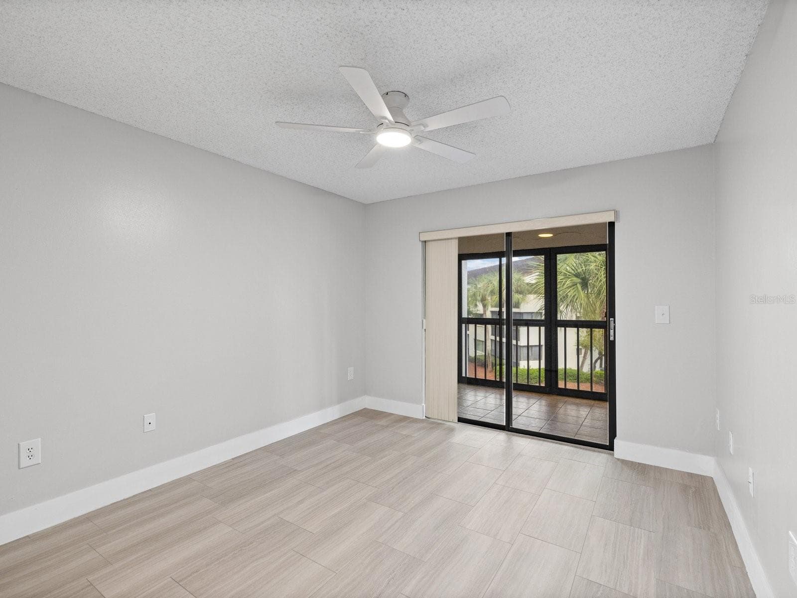 Primary bedroom with views of palms - 2593 COUNTRYSIDE BLVD #7304, CLEARWATER