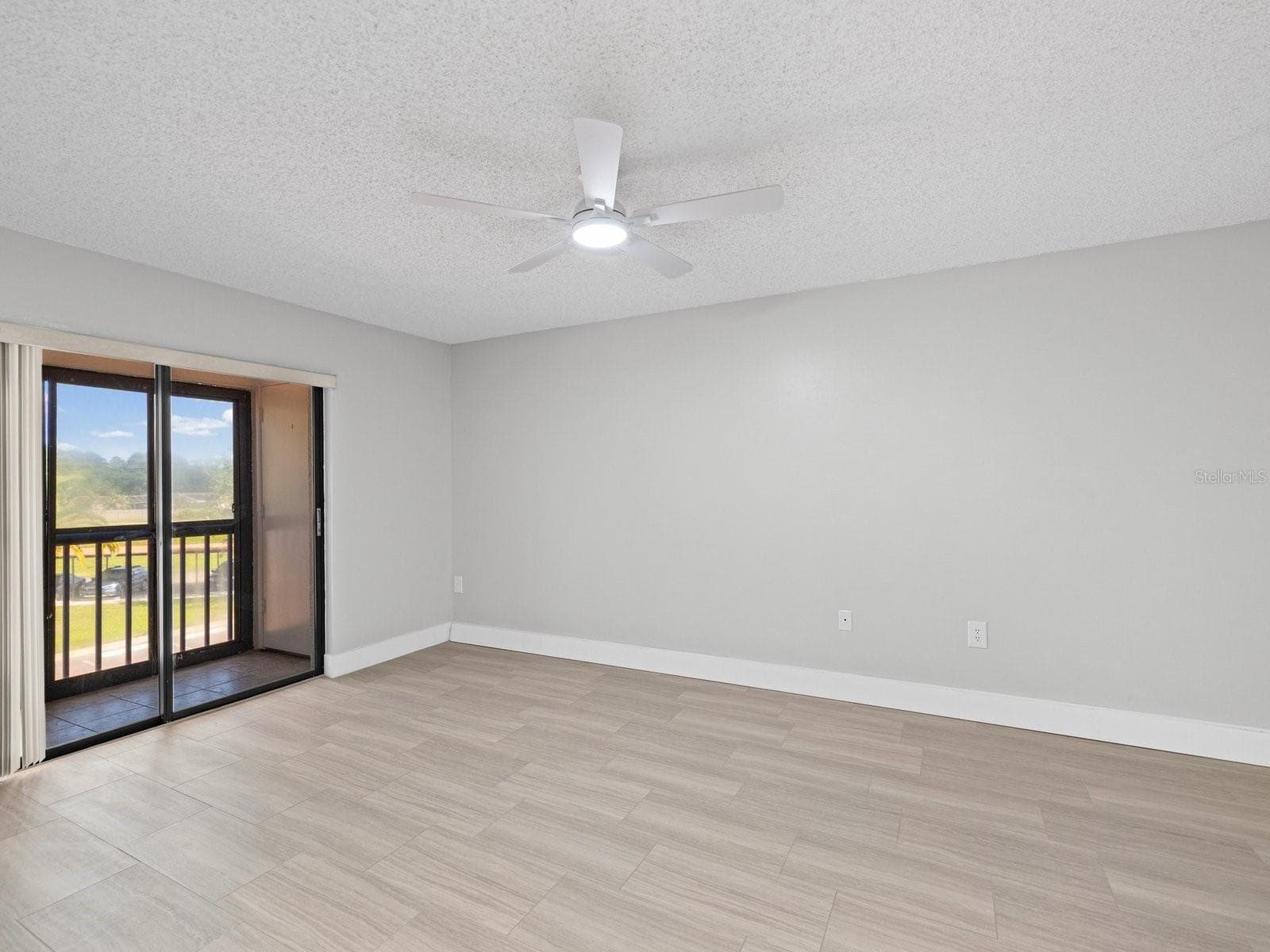 Primary bedroom with private screen patio and storage closet - 2593 COUNTRYSIDE BLVD #7304, CLEARWATER