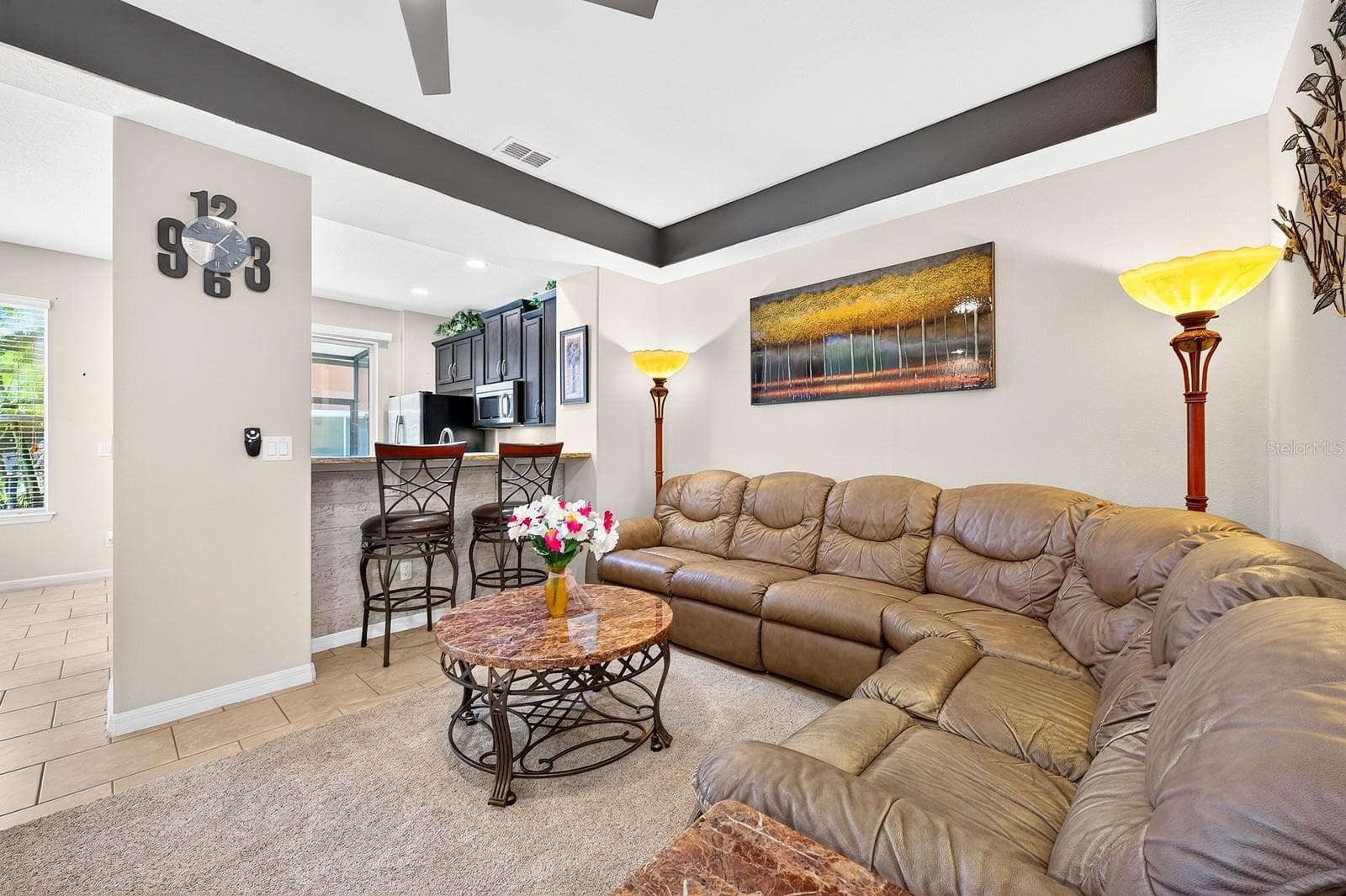 The Living Room features an ELEGANT TRAY CEILING and modern ceiling fan. - 2109 VICTORIA GLEN DR, SANFORD