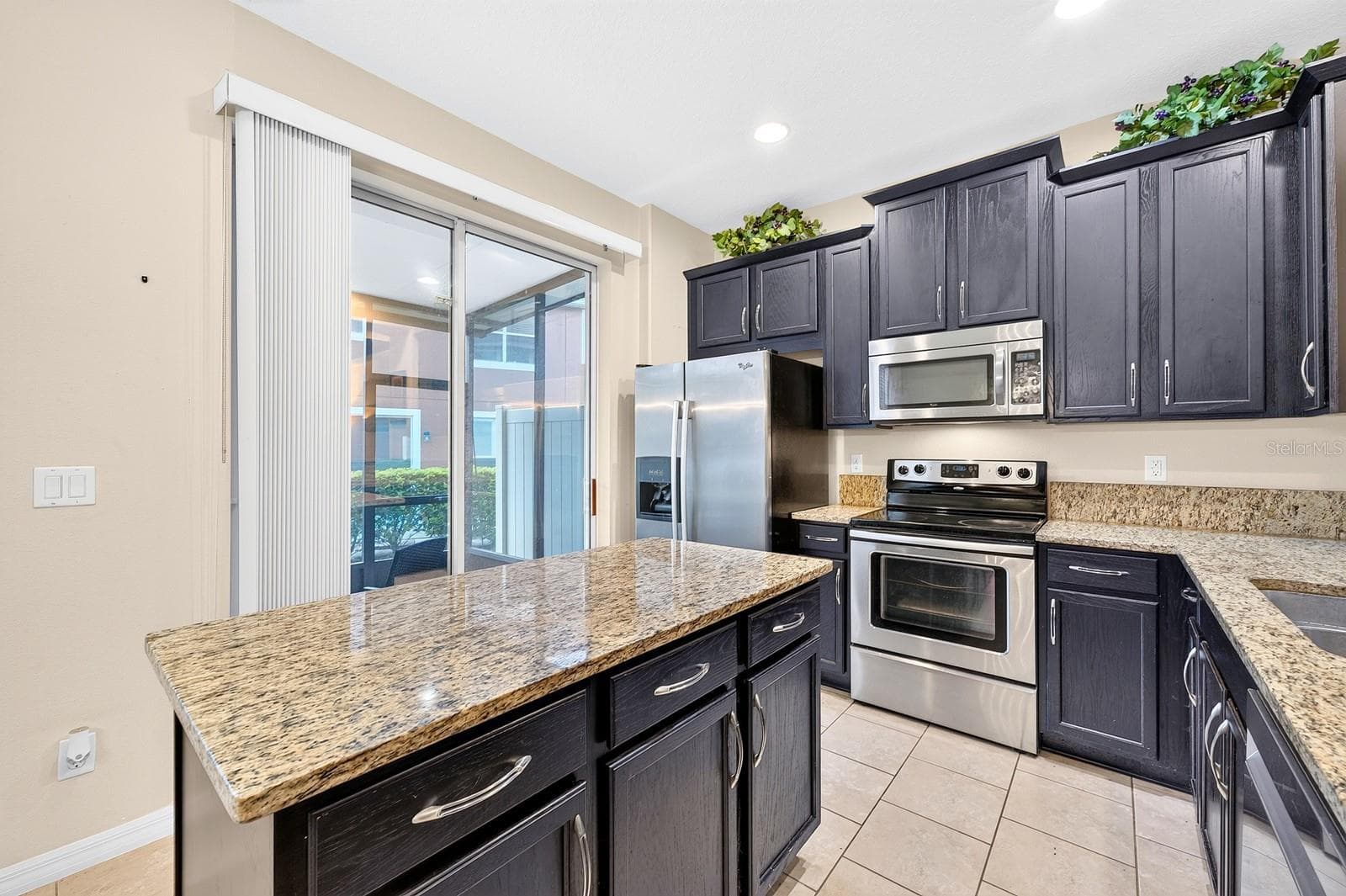 Sliding glass doors in the Kitchen, extend the living space outdoors. - 2109 VICTORIA GLEN DR, SANFORD