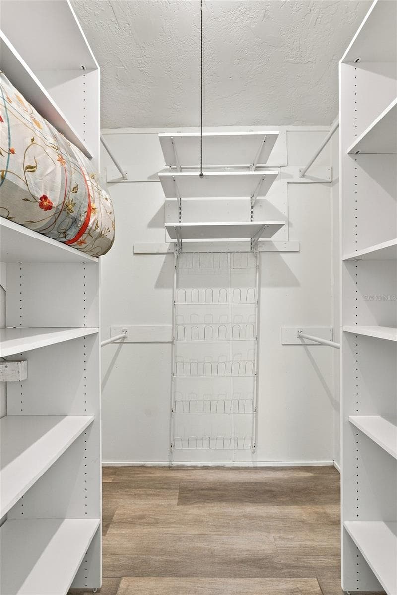 24. Owner's Retreat Walk in Closet (4.9 x 5.7') is Built Out for Maximum Storage!! - 112 PEACOCK CIR, SAFETY HARBOR