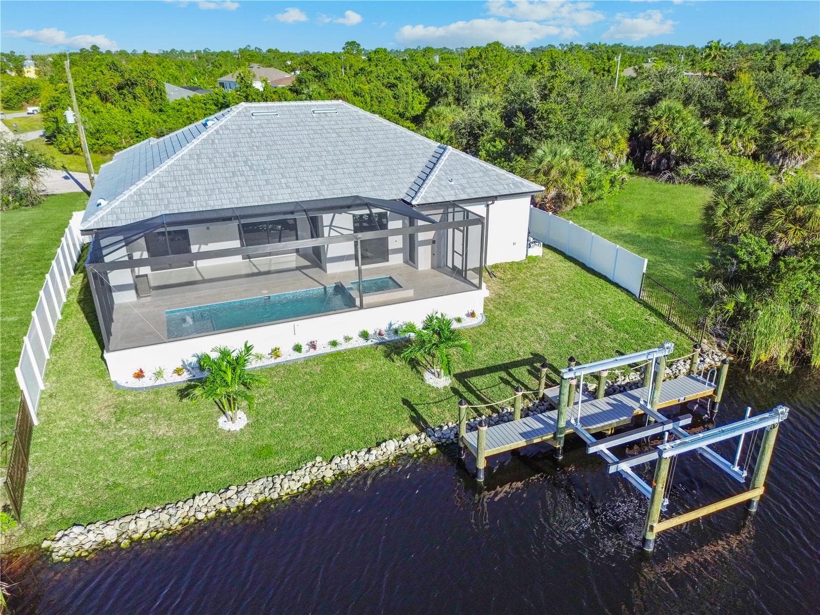 Rear Aerial View Showing Canal, Dock, Boat Lift and Pool Enclosure - 8568 SANTA CRUZ DR, PORT CHARLOTTE