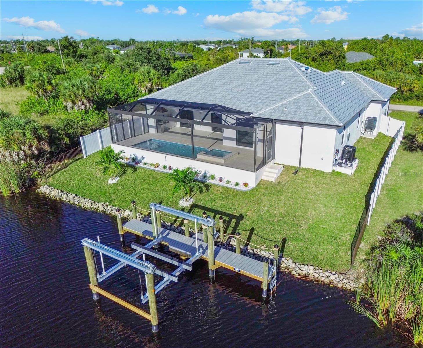 Rear Aerial View of Waterfront Home and Private Dock - 8568 SANTA CRUZ DR, PORT CHARLOTTE