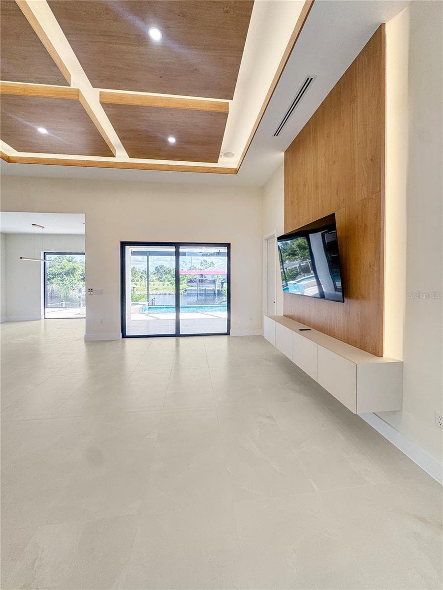 Living Room with Custom Ceiling and TV Feature Wall - 8568 SANTA CRUZ DR, PORT CHARLOTTE
