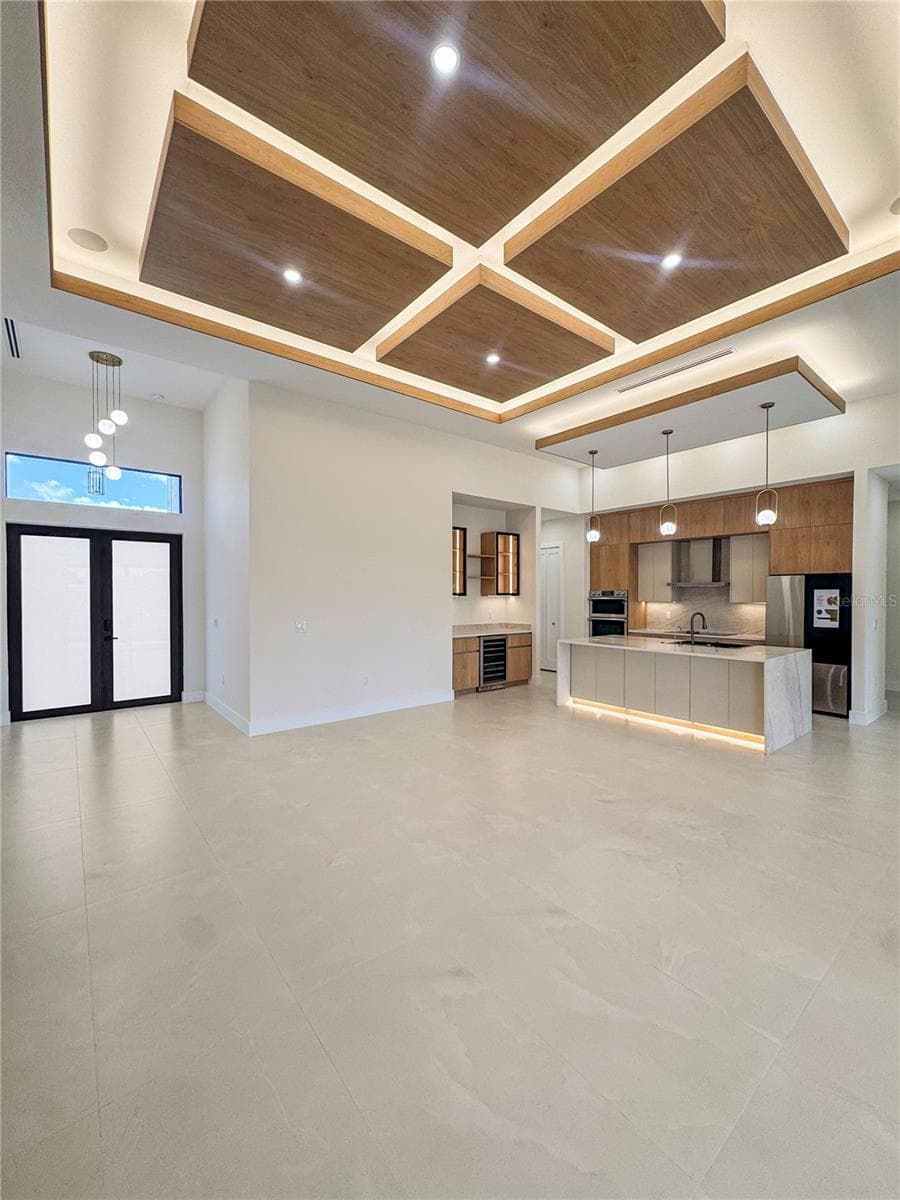 Living Area with Custom Ceiling and Kitchen View - 8568 SANTA CRUZ DR, PORT CHARLOTTE