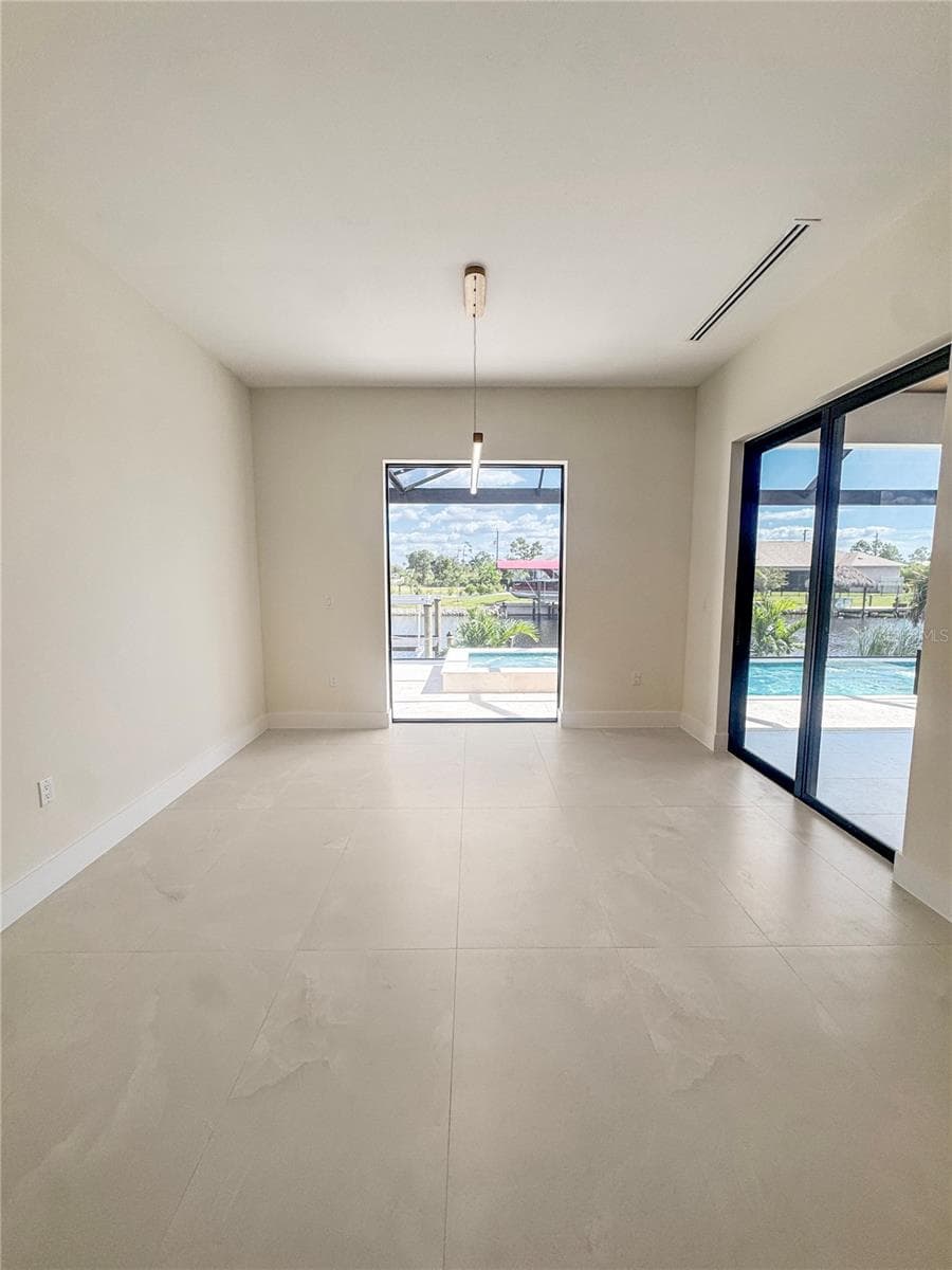 Wide View of Dining Area with Sliding Glass Doors to Lanai - 8568 SANTA CRUZ DR, PORT CHARLOTTE