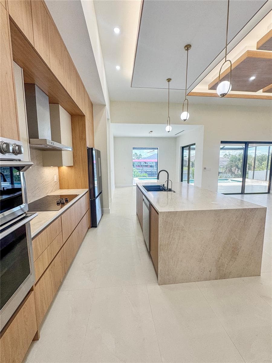 Kitchen with Island and Custom Cabinetry - 8568 SANTA CRUZ DR, PORT CHARLOTTE