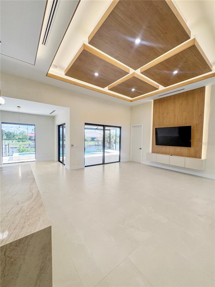 Living Room with Custom Ceiling and Sliding Glass Doors - 8568 SANTA CRUZ DR, PORT CHARLOTTE