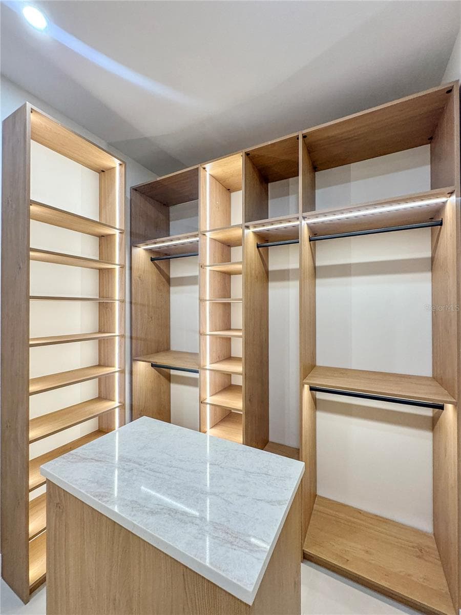 Master Walk-In Closet with Custom Cabinets and Island - 8568 SANTA CRUZ DR, PORT CHARLOTTE