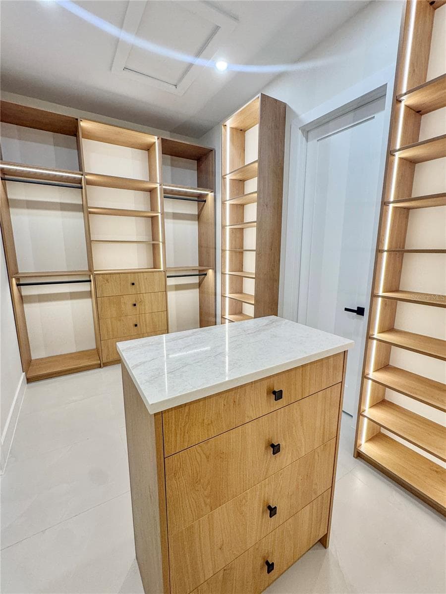 Master Walk-In Closet with Custom Cabinets and Island - 8568 SANTA CRUZ DR, PORT CHARLOTTE