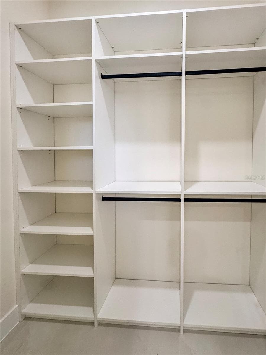 Bedroom 2 Walk-In Closet with Custom Cabinets - 8568 SANTA CRUZ DR, PORT CHARLOTTE