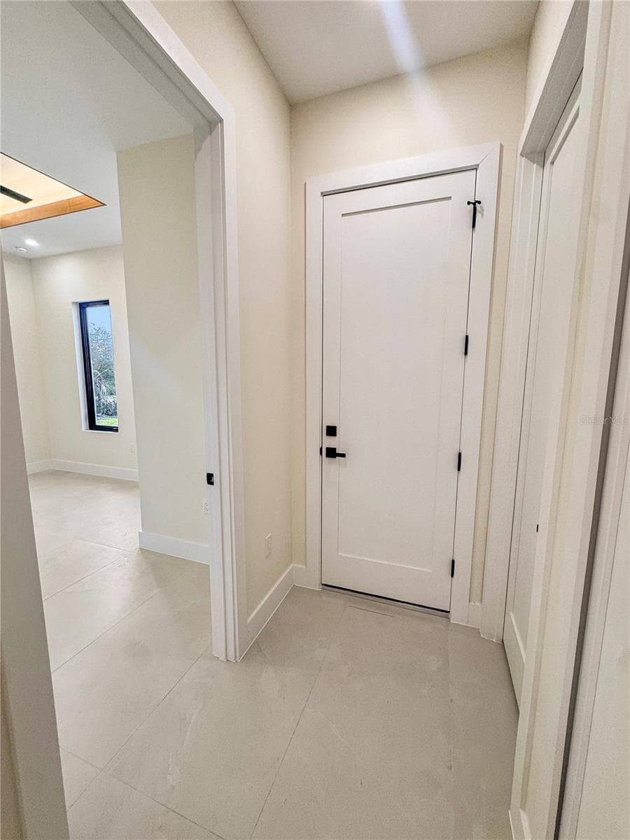 Hallway Leading to Bedroom 4, Laundry Room and Garage - 8568 SANTA CRUZ DR, PORT CHARLOTTE