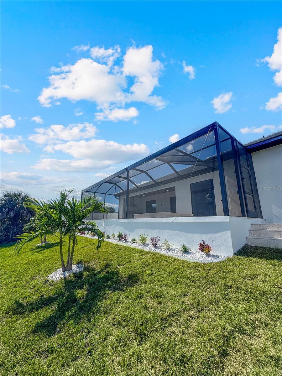 Rear Exterior View of Home and Pool Enclosure - 8568 SANTA CRUZ DR, PORT CHARLOTTE