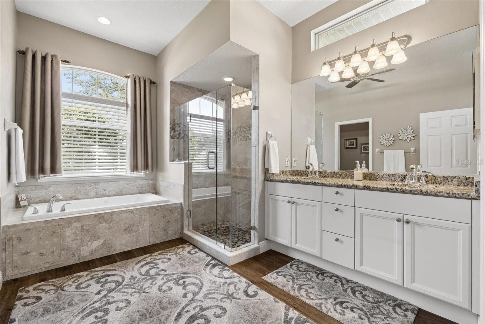 Primary Bathroom with dual sinks, tub and walk in shower - 9921 LAUREL VALLEY AVENUE CIR, BRADENTON