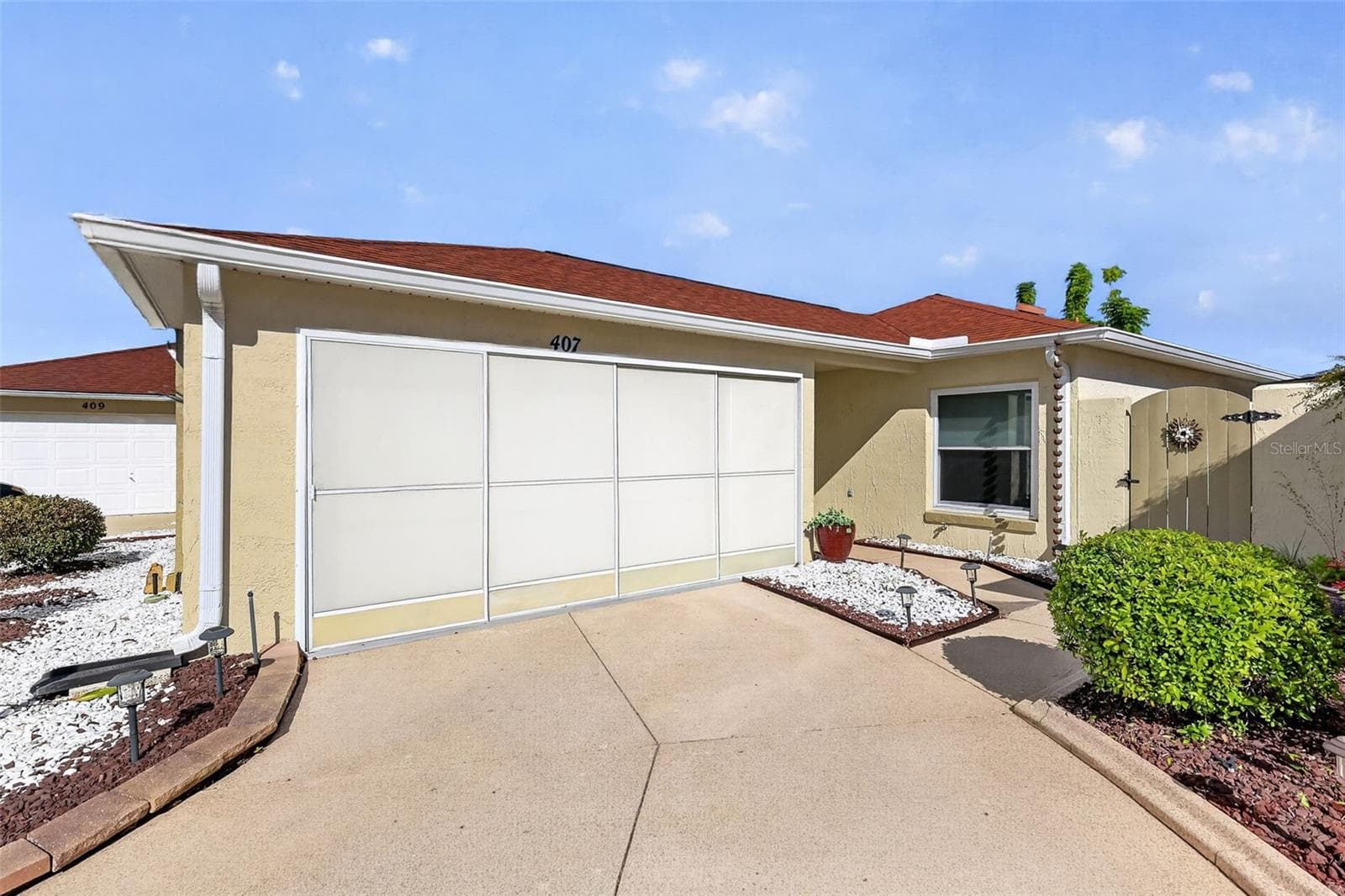 Front Elevation with Sliding Garage Door Screens - 407 CARMEL AVE, THE VILLAGES