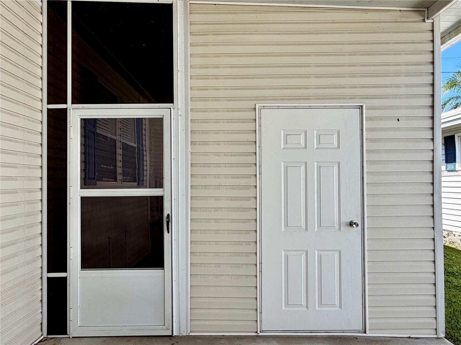 Door on right is the storage shed, door on left leads to the Sunroom - 34012 AZALEA DR N, PINELLAS PARK