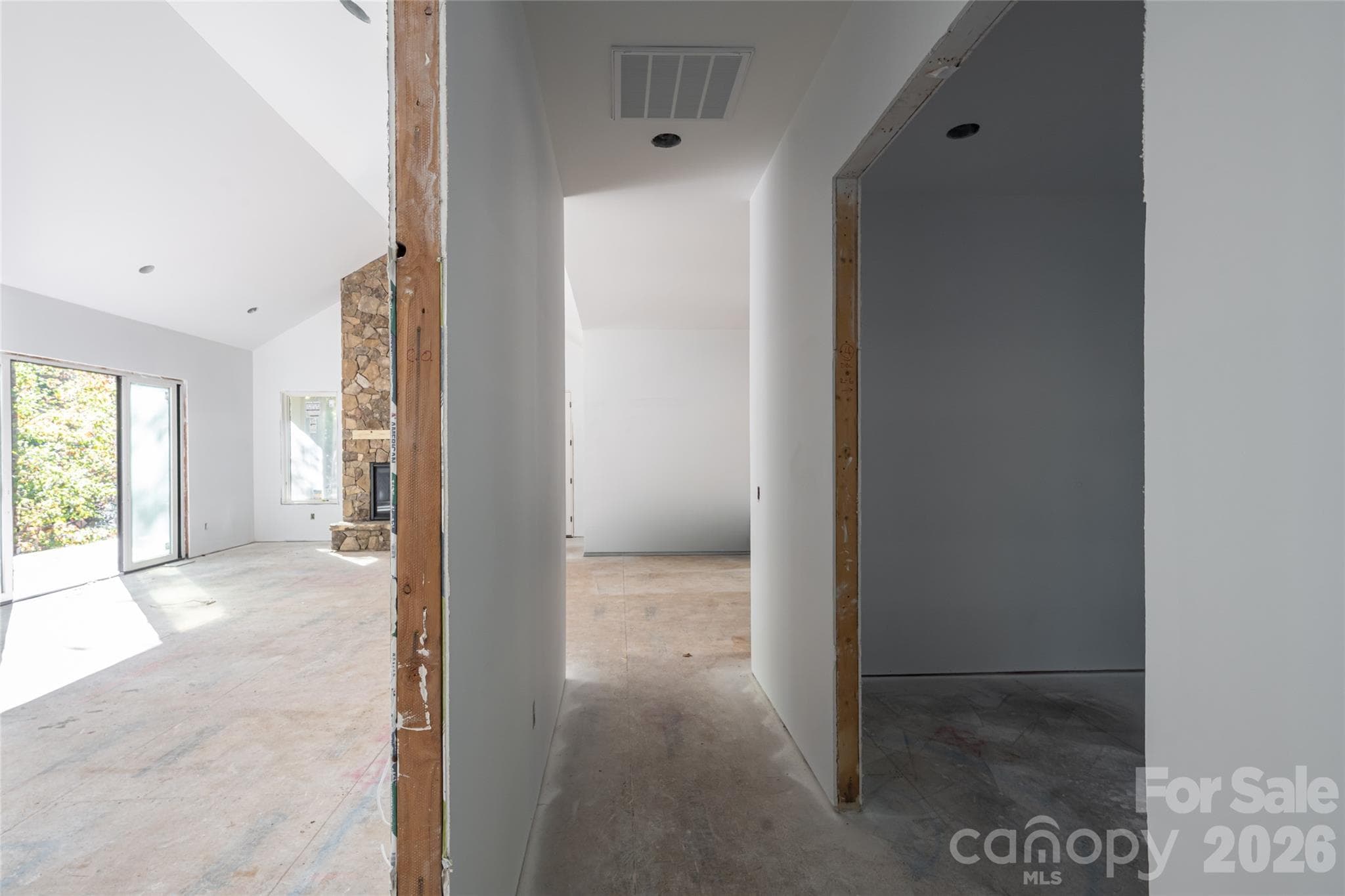 Hall leading to primary suite looking back towards foyer, kitchen, living room, and office on right. - 200 Bent Pine Trace, Hendersonville