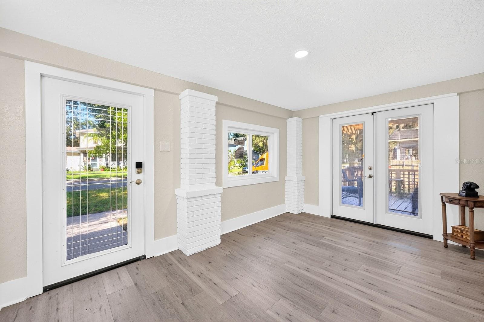 Step into the welcoming Foyer, where double doors open to a beautiful side porch. - 211 S MAPLE AVE, SANFORD