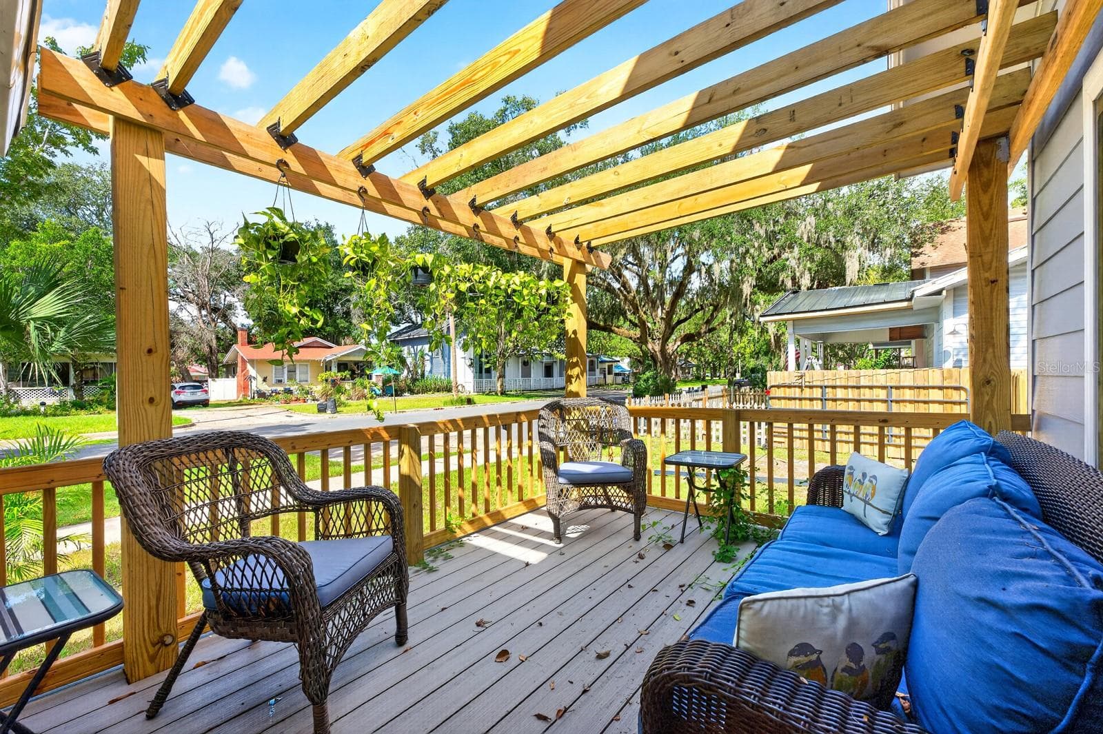 Double doors open to a beautiful side porch with a PERGOLA—a lovely spot to relax and enjoy the character of the property. - 211 S MAPLE AVE, SANFORD
