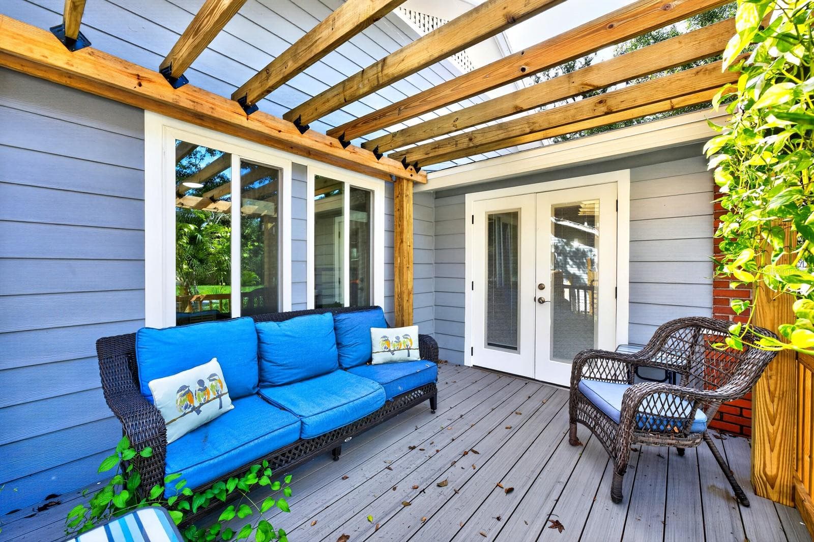 Double doors open to a beautiful side porch with a PERGOLA—a lovely spot to relax and enjoy the character of the property. - 211 S MAPLE AVE, SANFORD