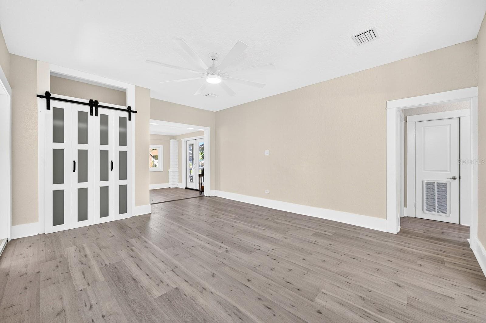 The spacious Living Room flows into the Dining Area and Kitchen. - 211 S MAPLE AVE, SANFORD