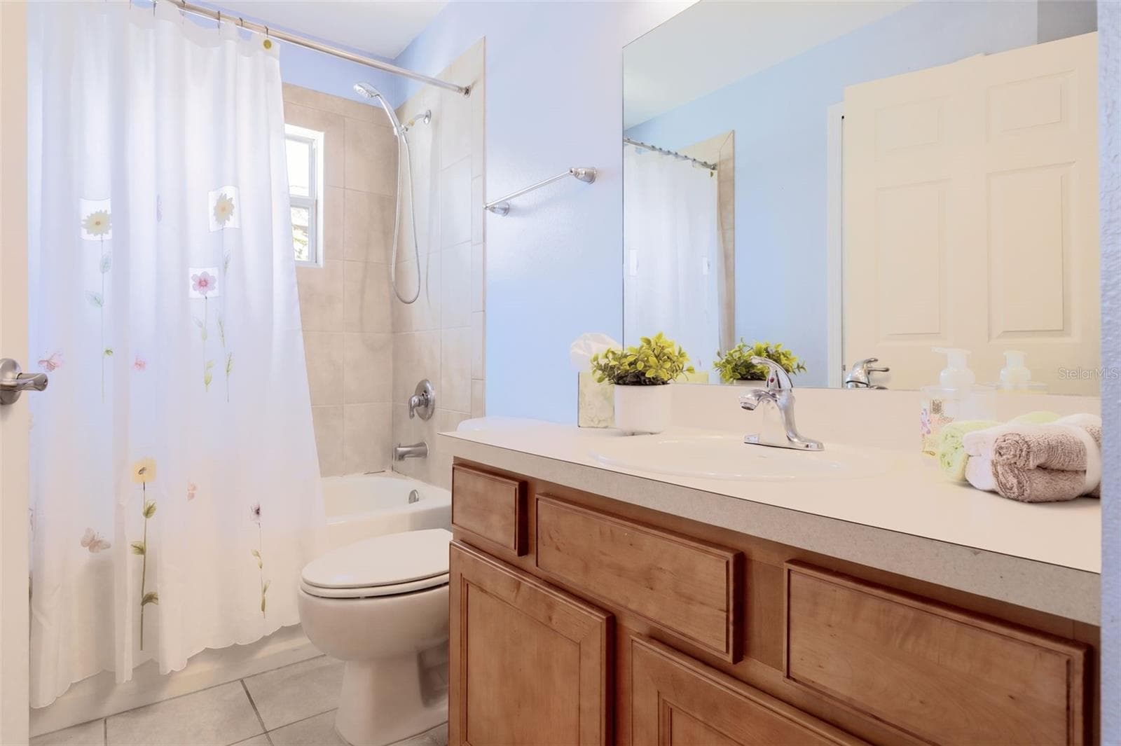 Guest Bathroom with maple wood vanity and tub/shower unit - 3437 GRENVILLE DR, WINTER HAVEN