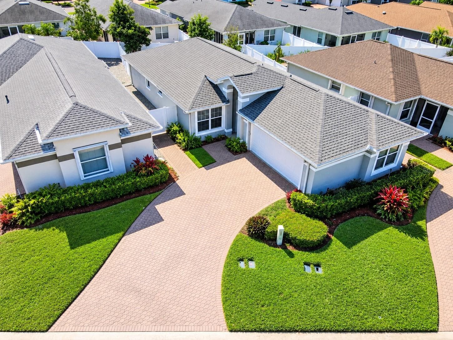 Architectural shingle roof (2020), HVAC system (2017), exterior lighting, water softener system, gutters, a glass entry storm door, and a two-car garage. - 3437 GRENVILLE DR, WINTER HAVEN