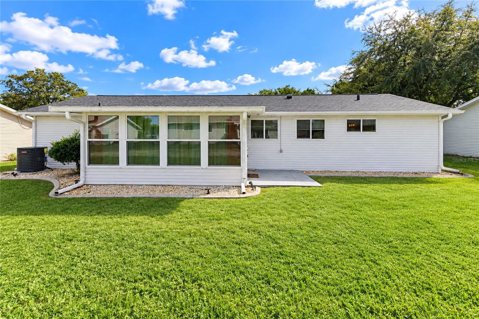 Rear glass enclosed patio view - 8169 SW 108TH LANE RD, OCALA