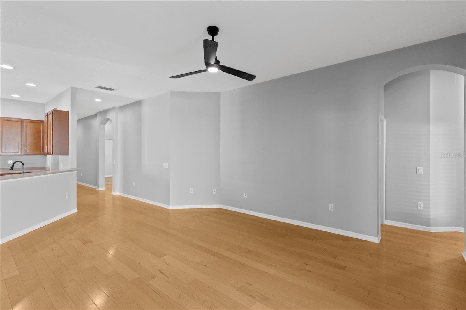 Living area off kitchen leading to Guest bedroom - 3214 BAYFLOWER AVE, HARMONY