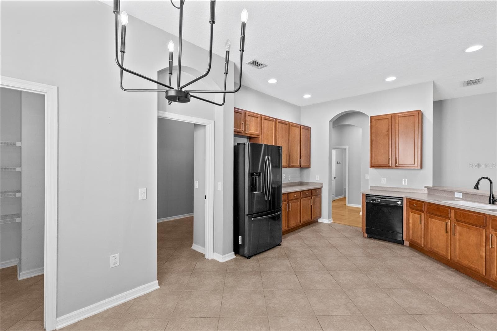 Kitchen showing pantry and laundry room - 3214 BAYFLOWER AVE, HARMONY