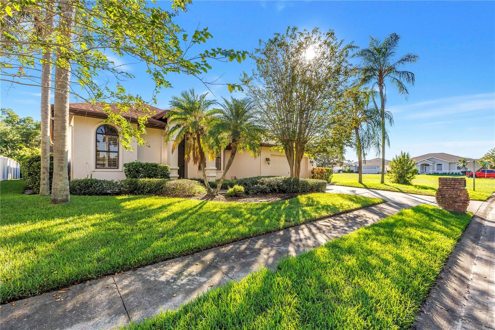 Charming exterior featuring sidewalks, a two-car driveway, and a two-car garage. Located in the beautiful Caya Costa nature preserve, perfect for safe, peaceful strolls at any time of day or night. - 1186 GASPARILLA DR NE, ST PETERSBURG