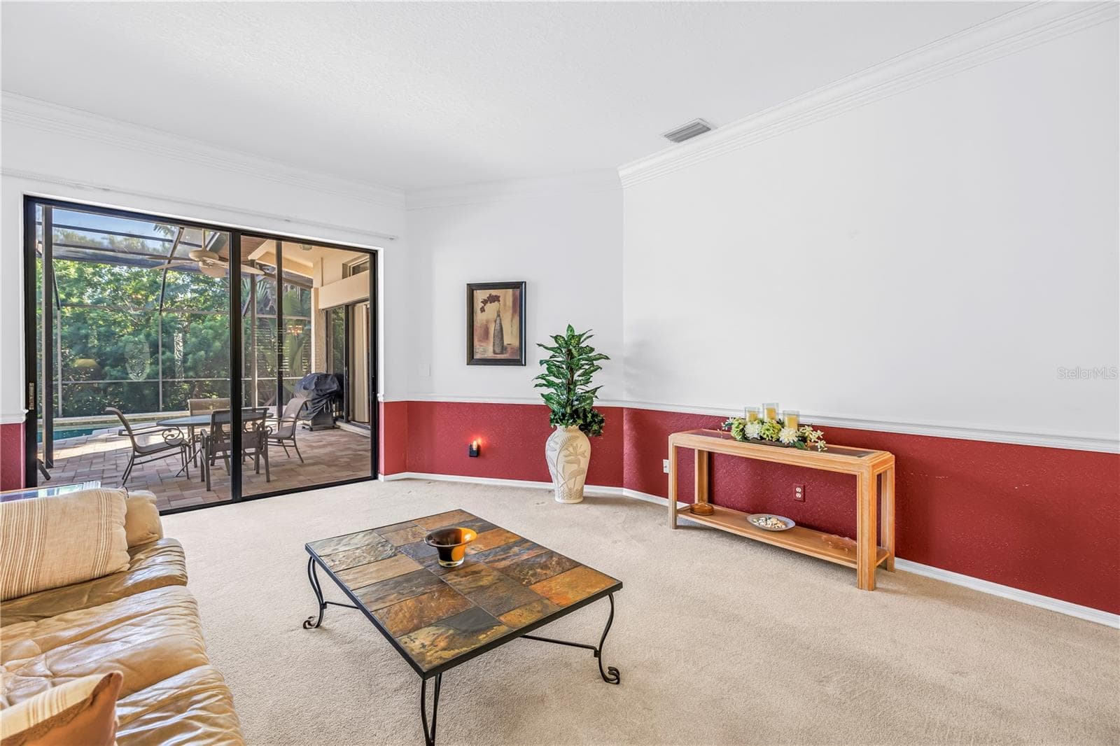 Crown molding and chair rail accent the 10-foot ceilings, creating a warm and welcoming entry to the home. - 1186 GASPARILLA DR NE, ST PETERSBURG