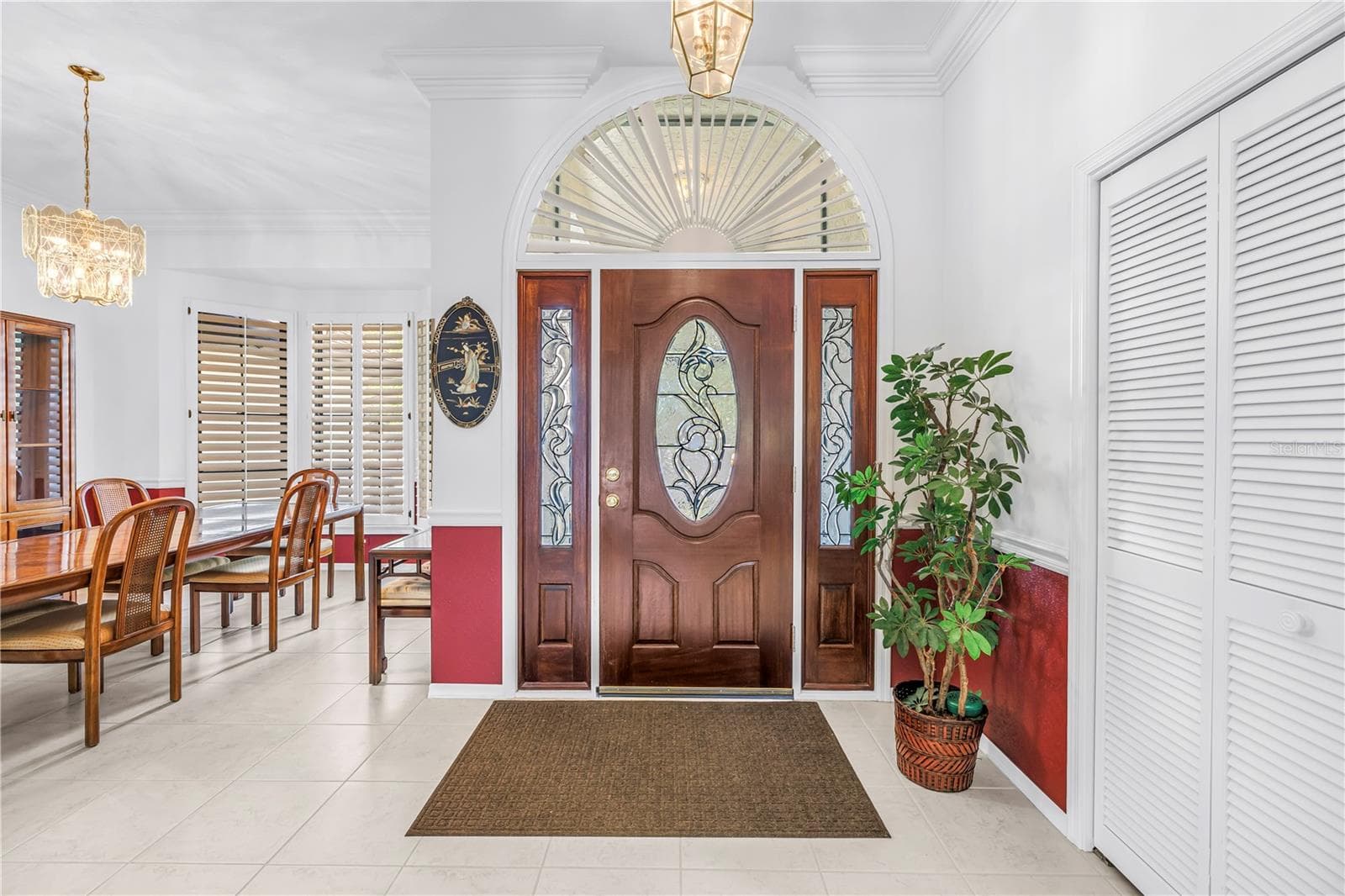 Foyer and adjacent formal dining room featuring abundant natural light and oversized windows. - 1186 GASPARILLA DR NE, ST PETERSBURG