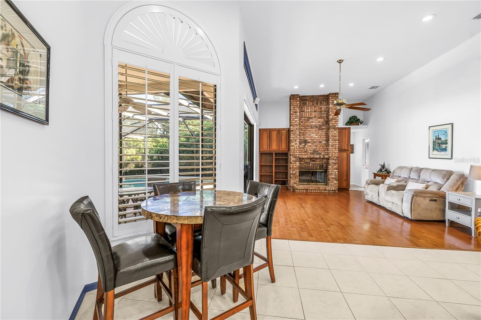 Breakfast or causal dining area adjacent to the kitchen and great room with views of the pool. - 1186 GASPARILLA DR NE, ST PETERSBURG