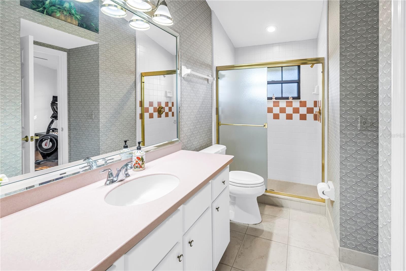 Bath 3 has a walk-in shower and access from the pool and Bedroom 3 - 1186 GASPARILLA DR NE, ST PETERSBURG
