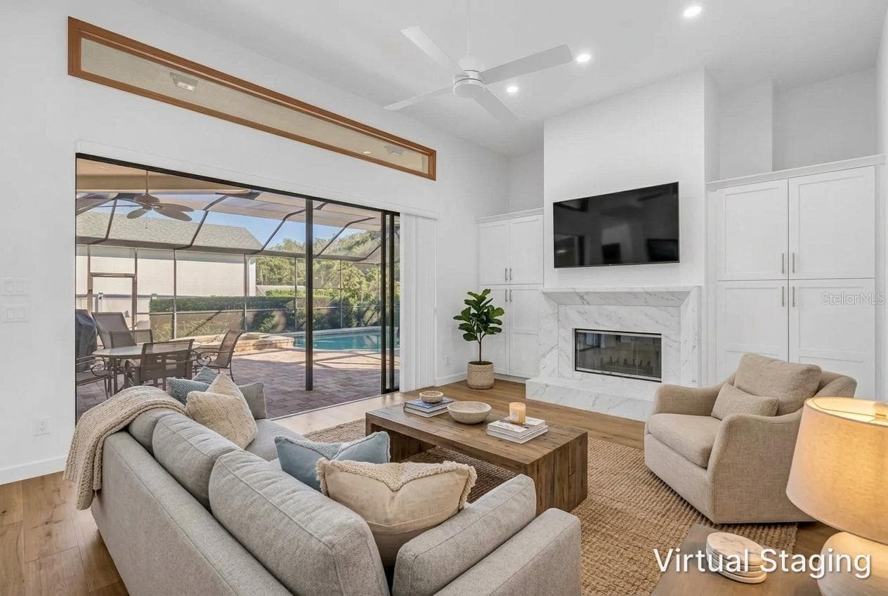 Virtual Updates and staging from previous photo. New Flooring, Fireplace refacing and hardwood flooring, and staging furniture. - 1186 GASPARILLA DR NE, ST PETERSBURG