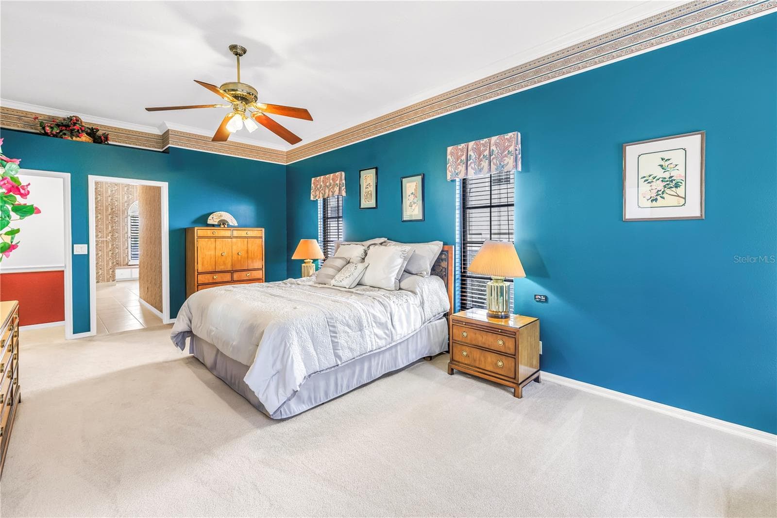 Current Photo of Primary bedroom and doors to the Primary Bath and the Living Space. 10 Foot Ceilings and 8-Ft Sliders to the pool deck - 1186 GASPARILLA DR NE, ST PETERSBURG