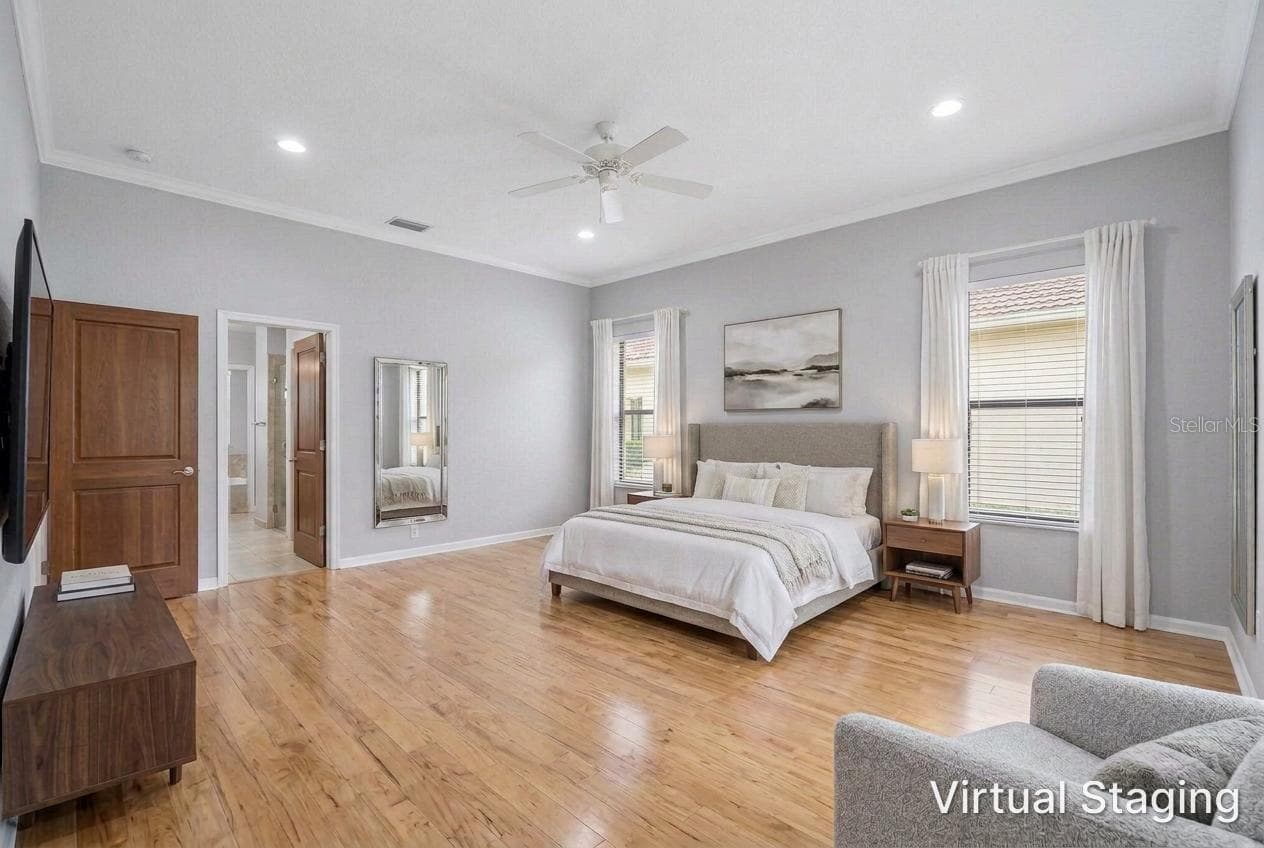 Virtual staging and updating of the previous two photos showing recessed lighting, hardwood flooring, new paint and staged furniture - 1186 GASPARILLA DR NE, ST PETERSBURG