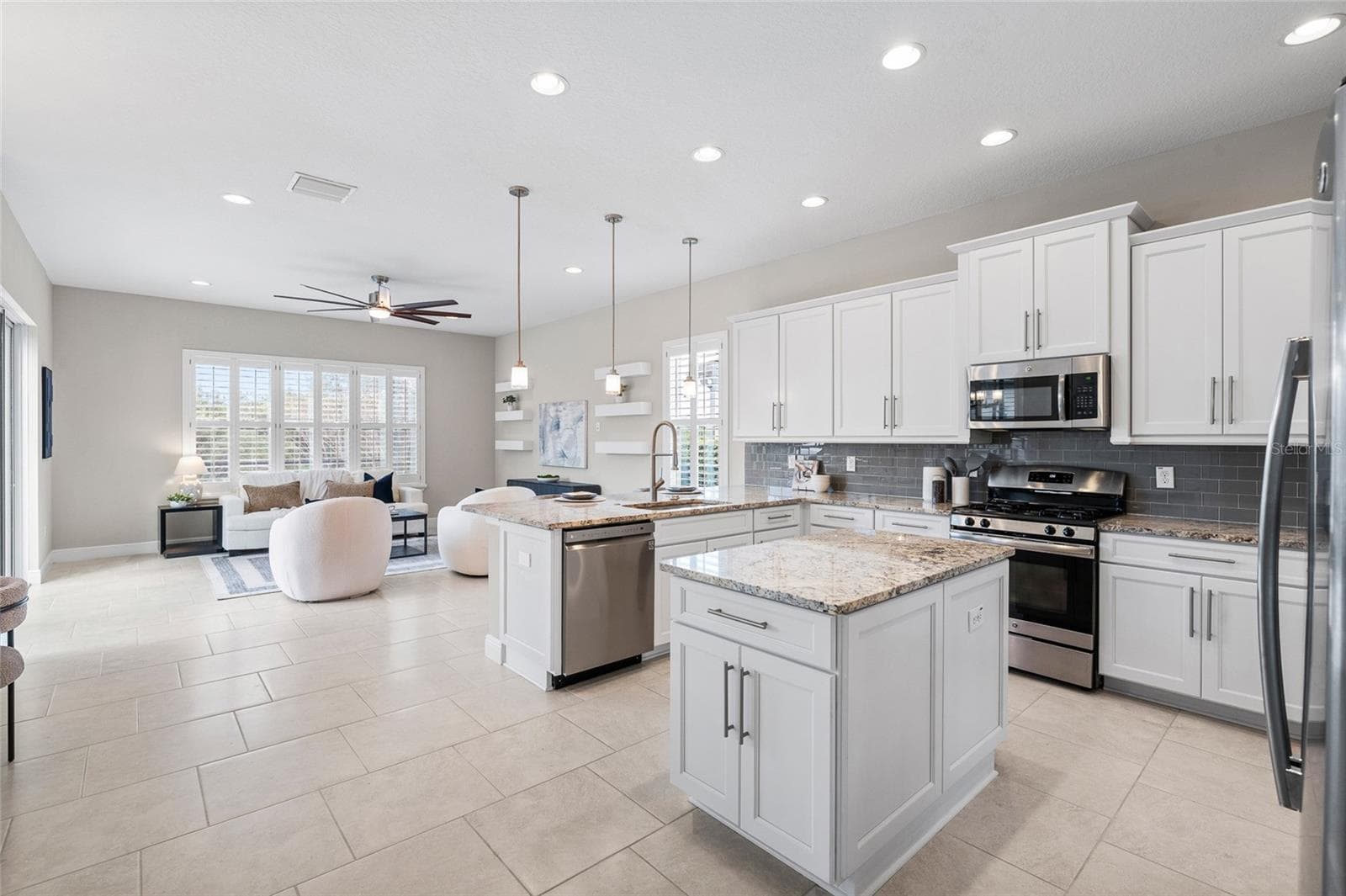 Kitchen open to breakfast nook and living room - 30351 TRISTANIA CT, WESLEY CHAPEL
