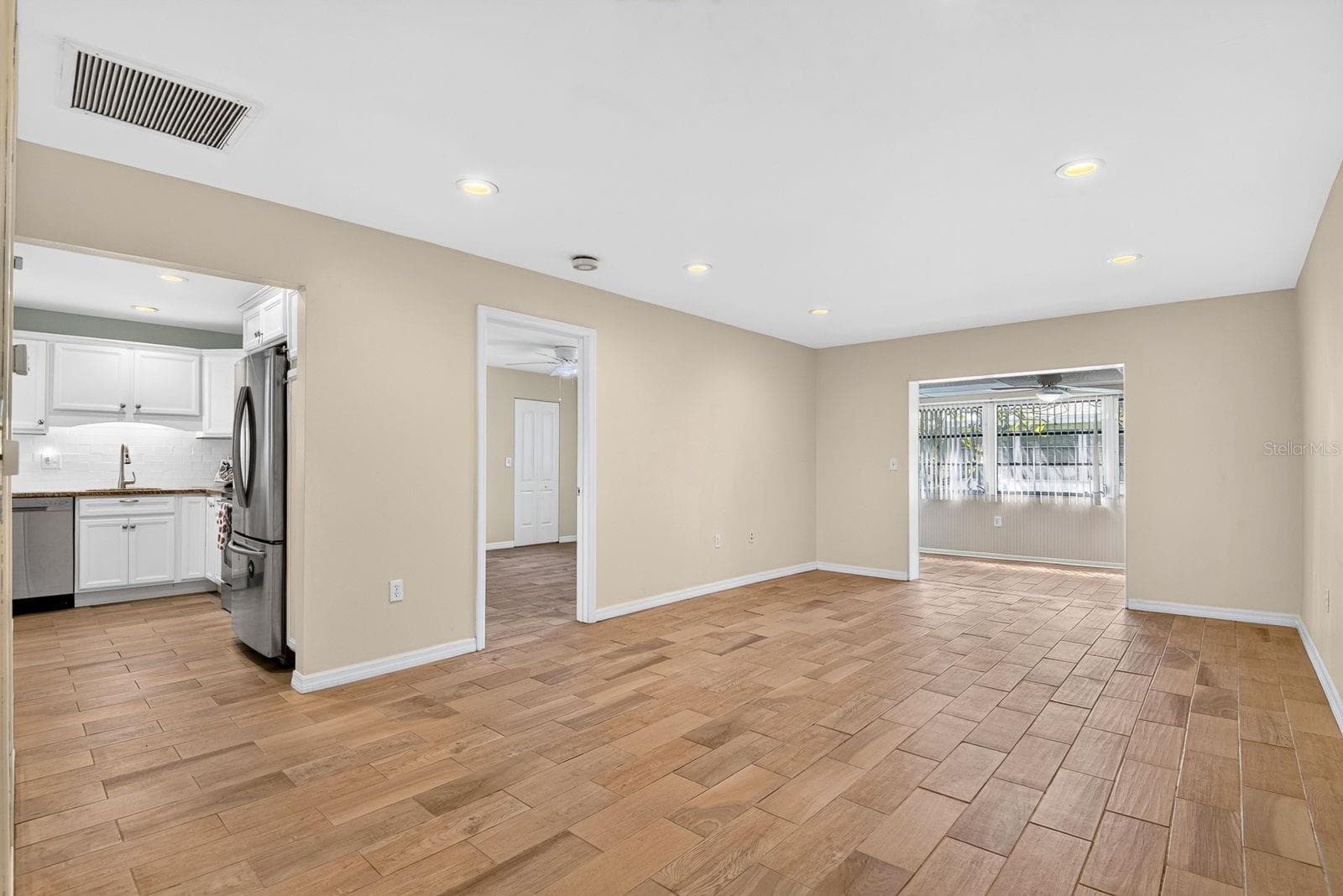 Living Room to Dining Area and Kitchen and Primary Bedroom - 390 301 BLVD W #10C, BRADENTON