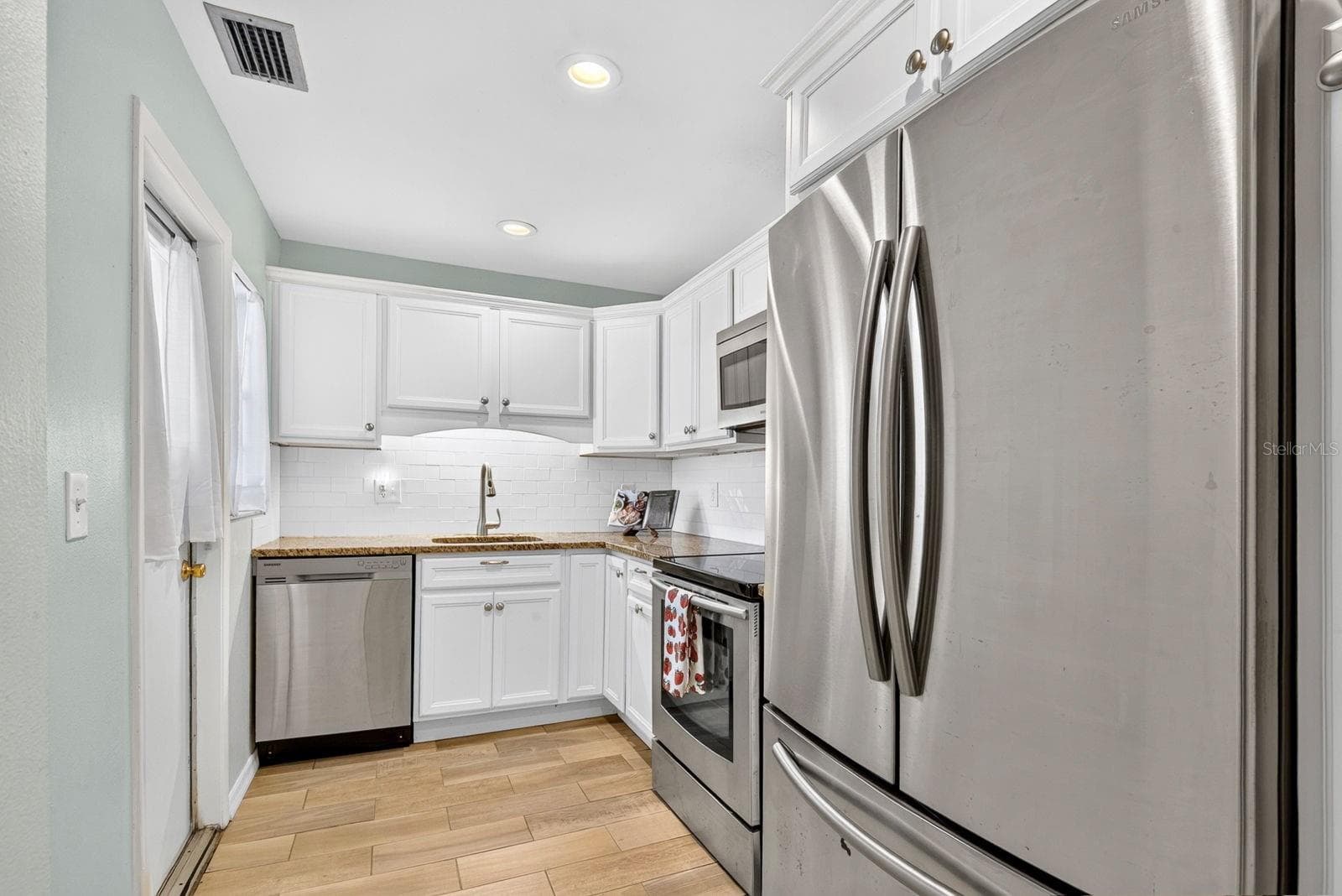 Kitchen with Door to Carport - 390 301 BLVD W #10C, BRADENTON