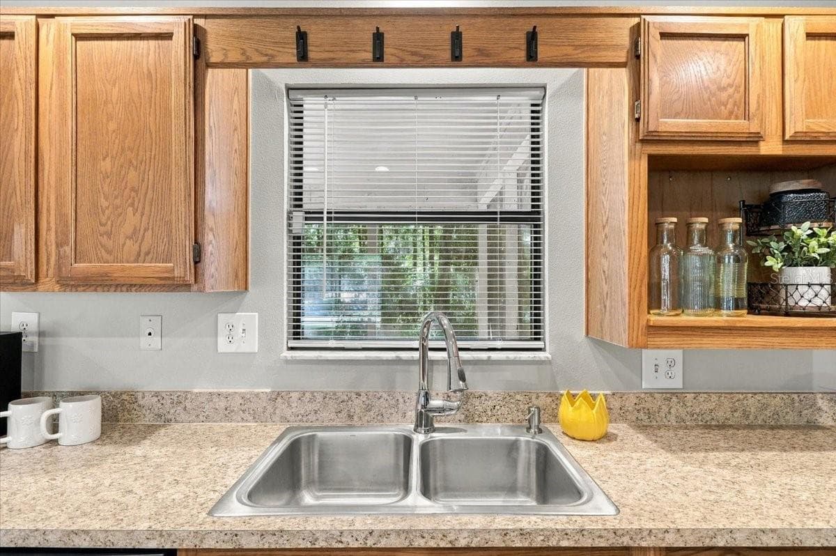Kitchen window has a bar to the porch. Wash the dishes with a view! - 5244 QUIET CREEK LN, LAKELAND