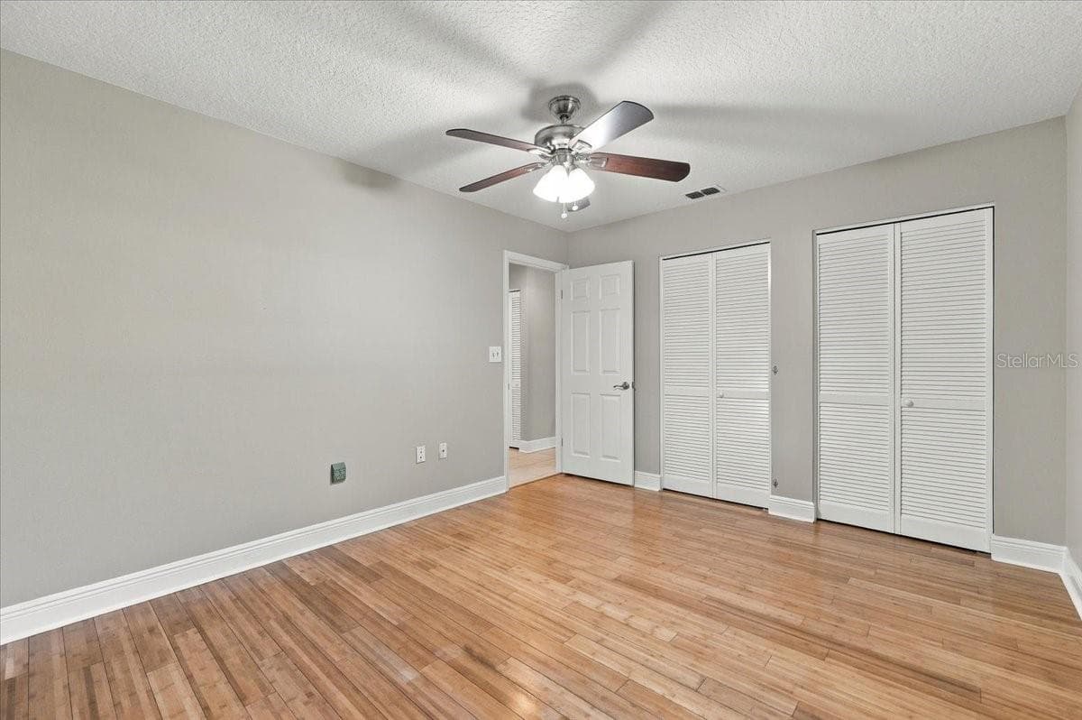 2nd bedroom with double closets, ceiling fan, new blinds and bamboo hardwood flooring. - 5244 QUIET CREEK LN, LAKELAND