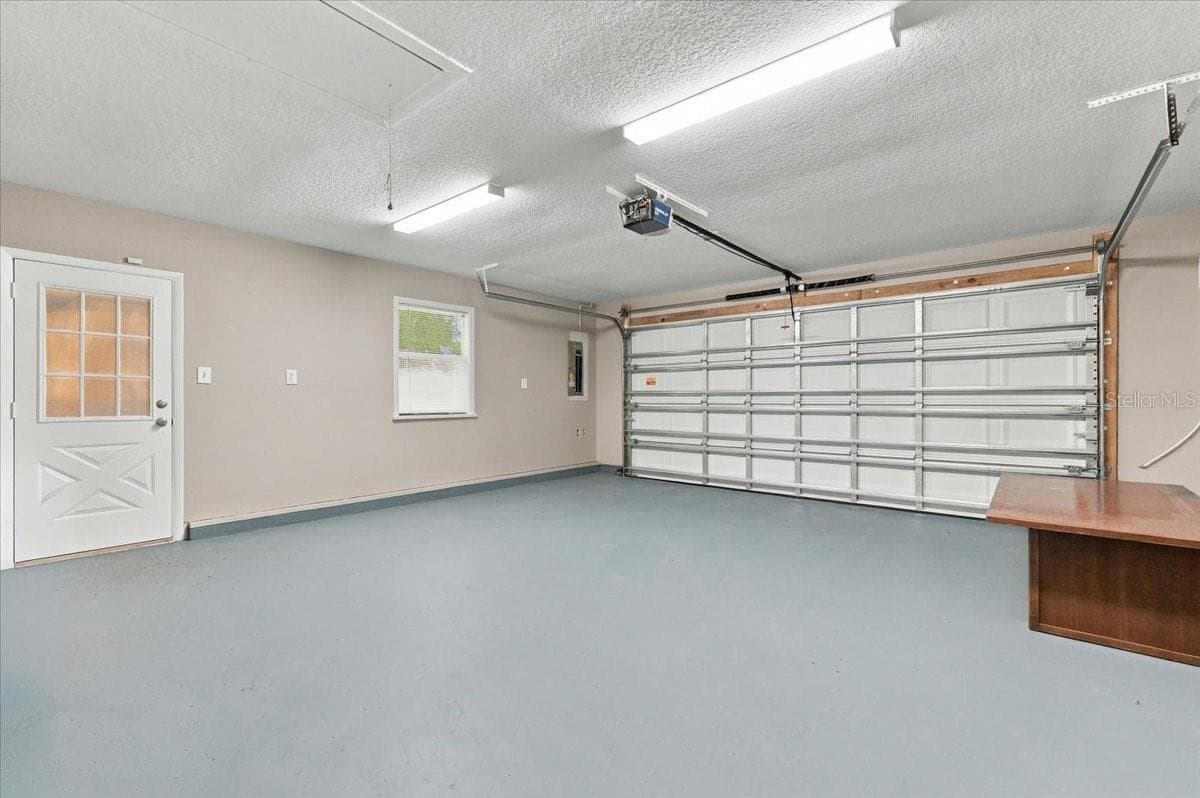 2 car garage with service door and new impact garage door with opener. - 5244 QUIET CREEK LN, LAKELAND