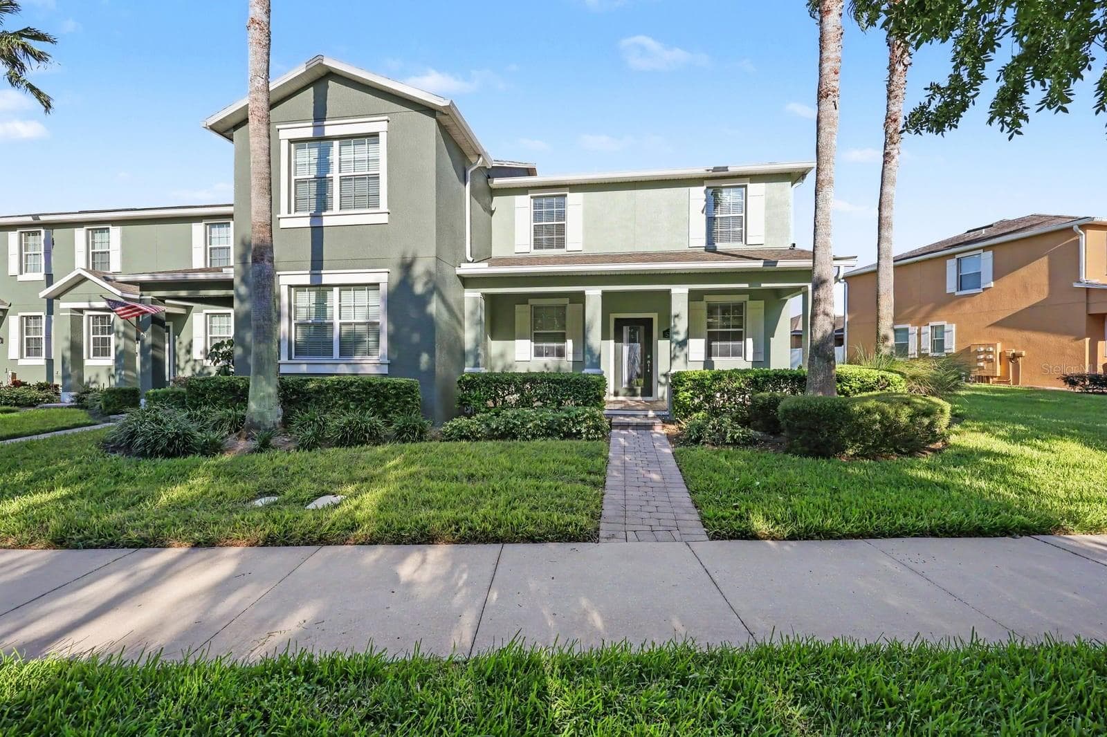 Charming two-story home with green exterior and manicured landscaping - 5705 NEW INDEPENDENCE PKWY, WINTER GARDEN