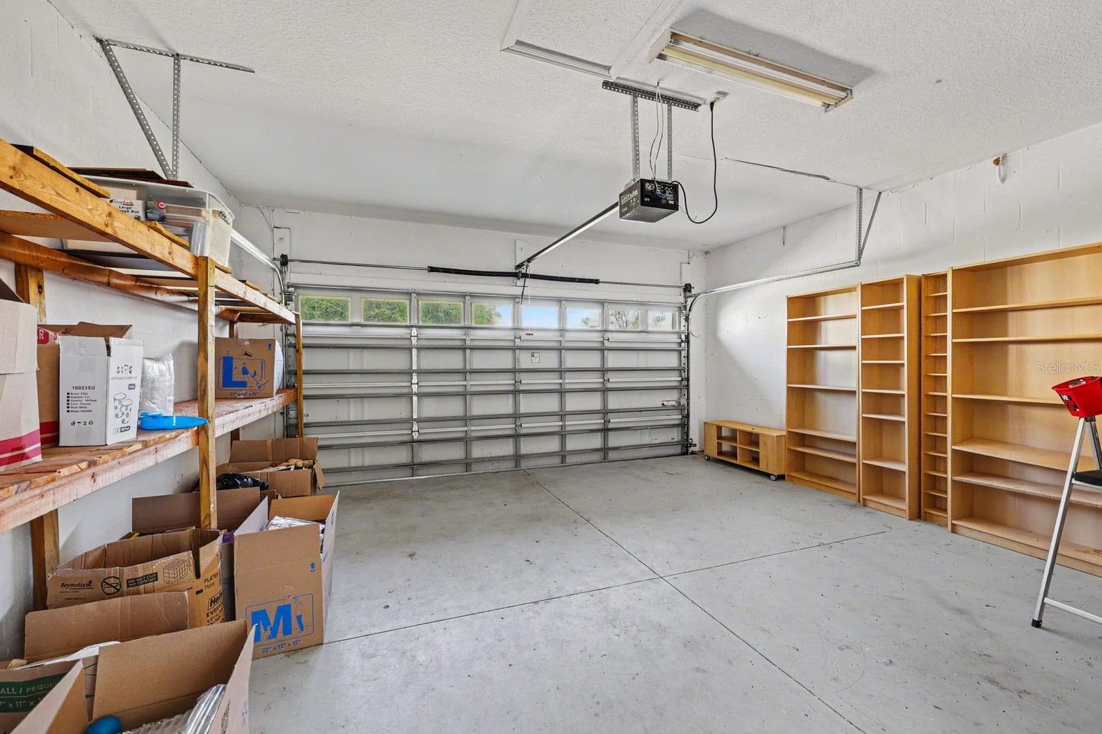 Spacious Two-Car Garage with Storage Shelving and Overhead Storage - 5705 NEW INDEPENDENCE PKWY, WINTER GARDEN